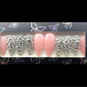 Nude pink and rhinestone accent press on nails.